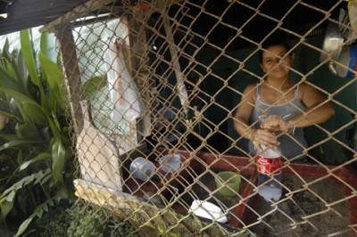 Just west of Bejuco, on the Peninsula de Nicoya, a woman cleans her kitchen.