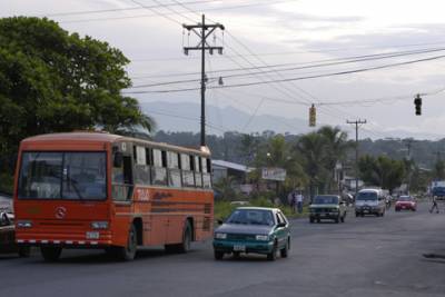 Traffic barrels down the main road coming into Puerto Limon.