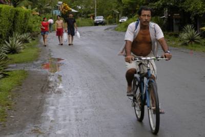 A local rides his bike down the main street.