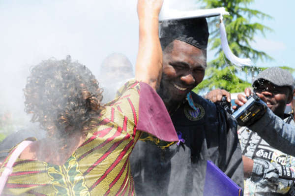 Wemba-Koy Okonda gets powdered after graduating from UW Tacoma
