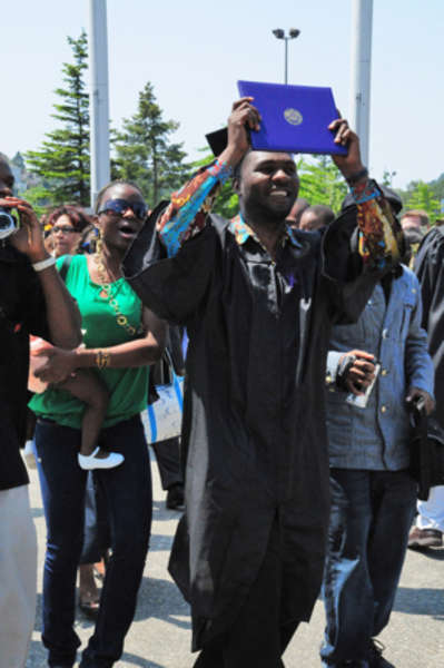 Wemba-Koy Okonda celebrates after receiving his UWT bachelor's degree.