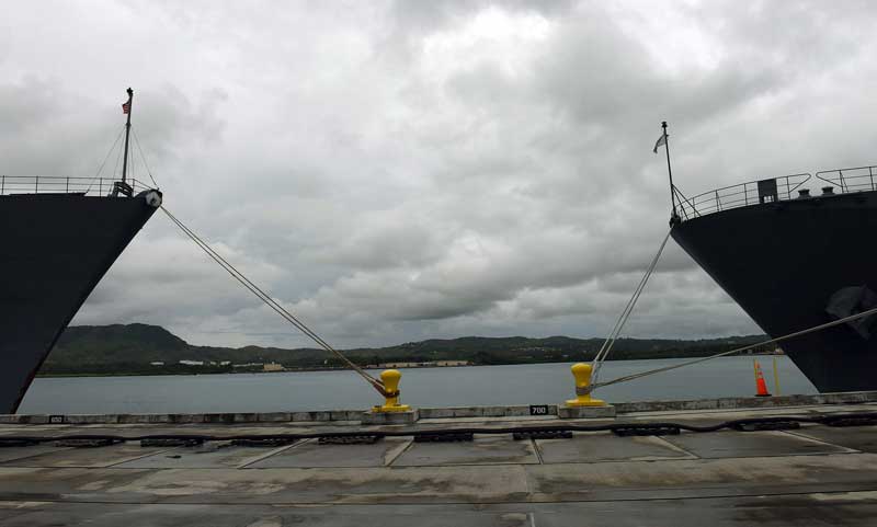 The American Naval ship Ashland, a dock landing ship, faces the Japanese ship Murroto at the newly refurbished Victor Wharf on Naval base Guam on Aug. 5, 2015. The Pentagon and Japan are spending hundreds of millions of dollars on harbor improvements to handle more ships and Marines. (Tiffany Tompkins-Condie, McClatchy.)