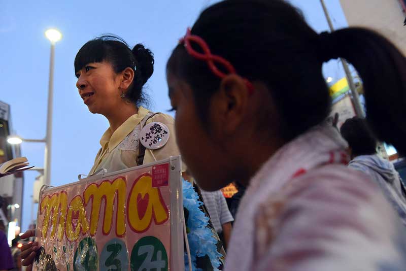 Miyumi Shiroma took the stage in front of approximately 1,500 people gathered in front of the Okinawan Prefectural Government offices in Naha to protest a security bill endorsed by Prime Minister Shinzo Abe to beef up Japanese military powers on July 31, 2015. Shiroma believes military expansion in the area will make Okinawa a target for a military attack. (Tiffany Tompkins-Condie, McClatchy.)