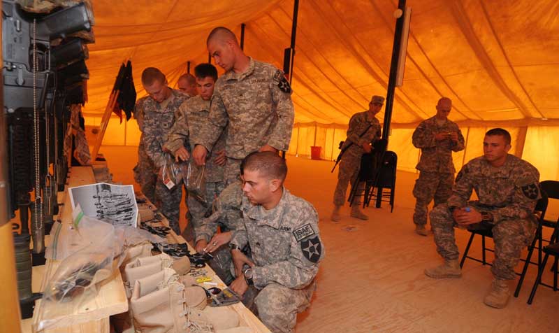 Lt. Dan Boirum, right, watches members of 1-17 Charlie Company pack up mementos at the memorial service at FOB Frontenac in October 2009, for seven fellow soldiers of 2nd Platoon Charlie Company that lost their lives in a large river bed IED blast. (Courtesy photo.)